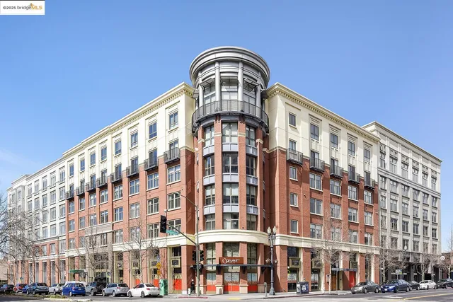 a front view of a multi story building with yard