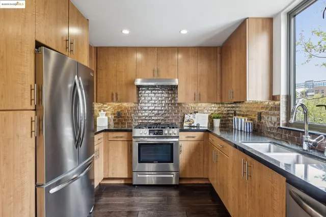 a kitchen with stainless steel appliances a sink and cabinets