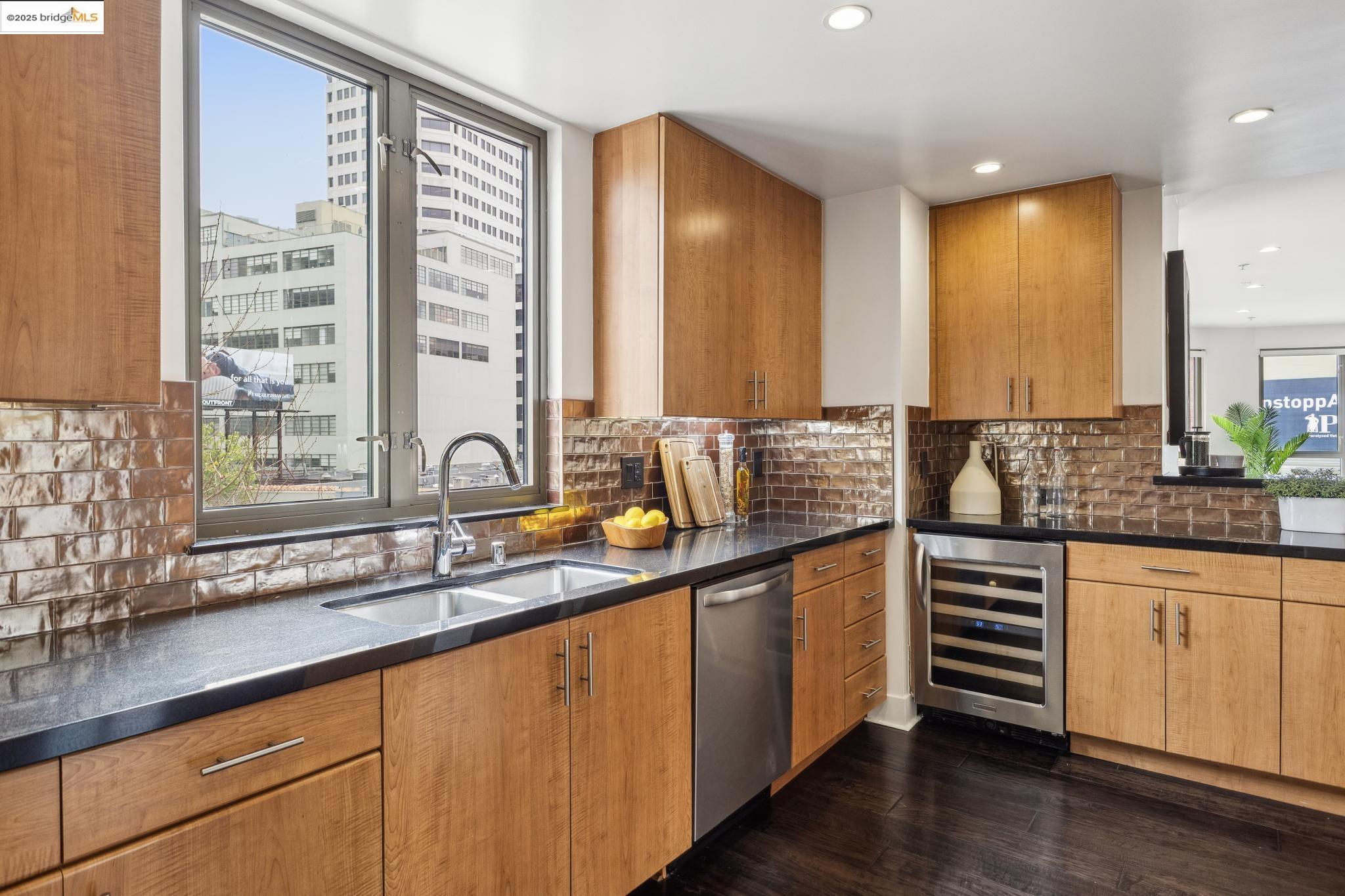 438 West Grand Avenue, Unit 420 Oakland, CA 94612 - Photo 8 of 58 a kitchen with stainless steel appliances a sink and cabinets