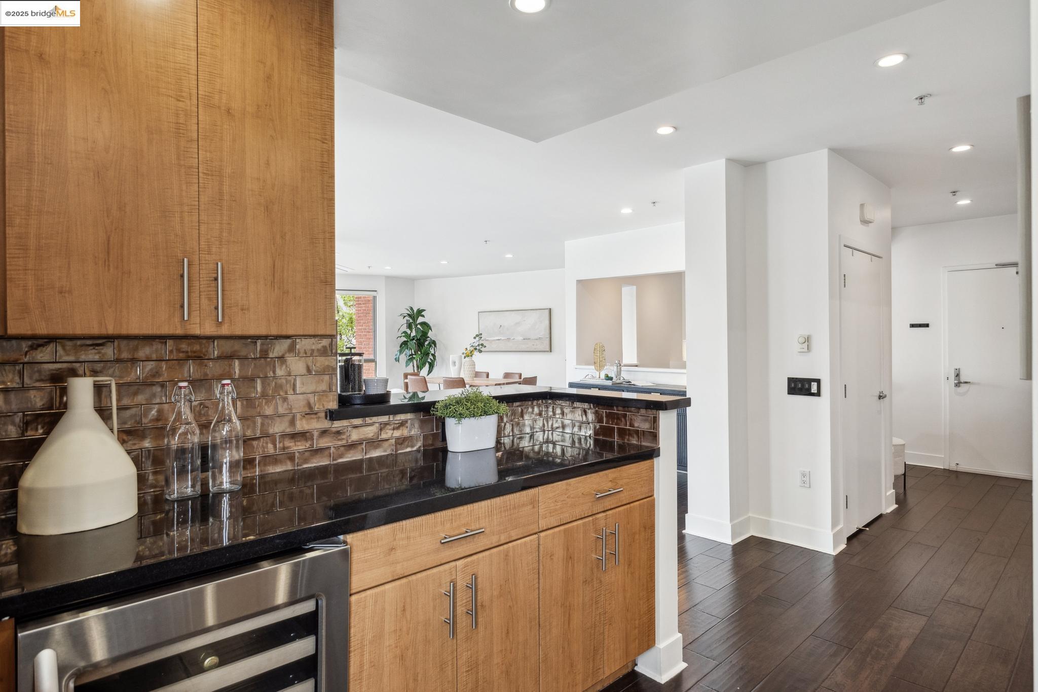 438 West Grand Avenue, Unit 420 Oakland, CA 94612 - Photo 10 of 58 a kitchen with stainless steel appliances granite countertop a sink and cabinets