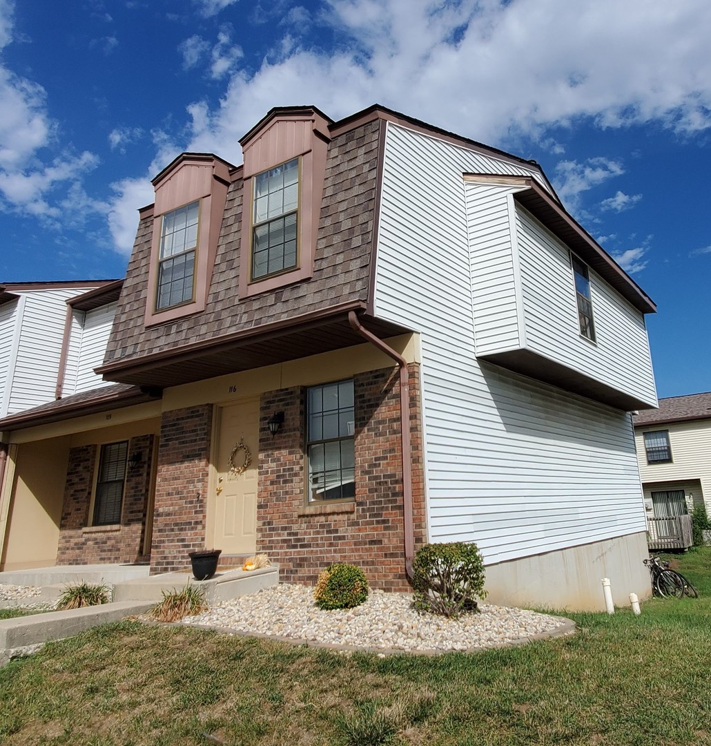 700 North Adelaide Street, Unit 116 Normal, IL 61761 - Photo 2 of 3 a front view of a house with garden