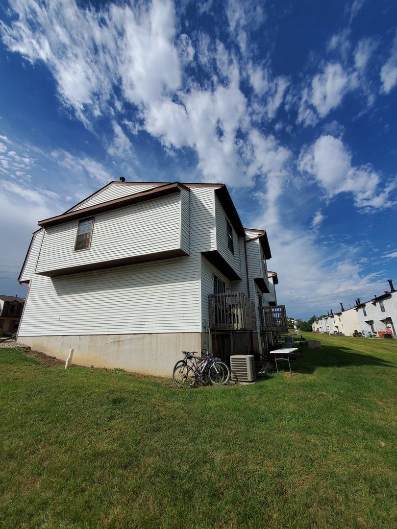 700 North Adelaide Street, Unit 116 Normal, IL 61761 - Photo 3 of 3 a house with green field in front of it