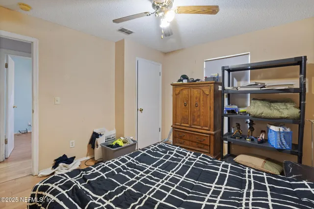 a bedroom with furniture and a window