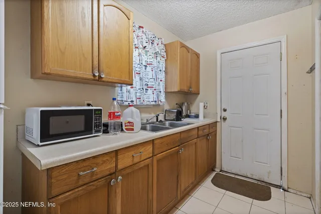 a kitchen with stainless steel appliances granite countertop a sink a stove and cabinets