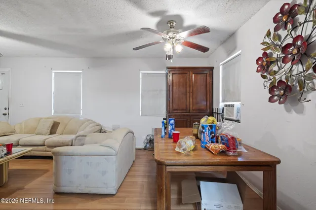 a living room with furniture and a ceiling fan