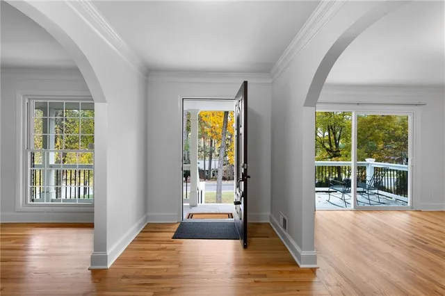 a view of an entryway with wooden floor and door