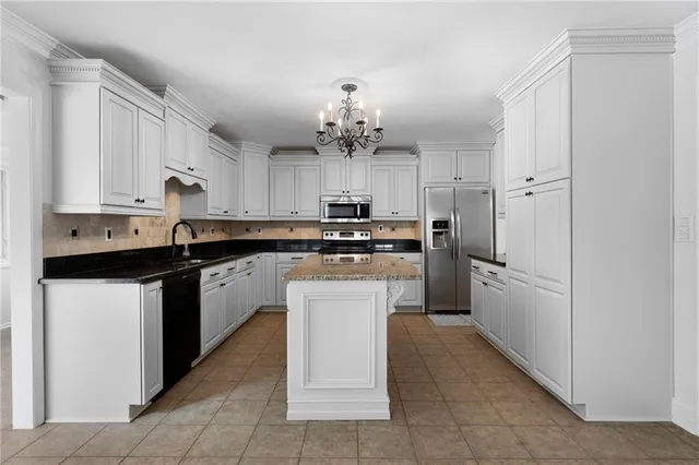 a kitchen with stainless steel appliances granite countertop a refrigerator sink and cabinets