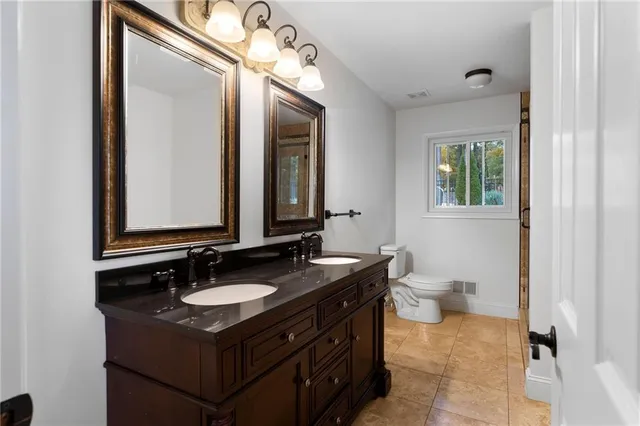 a bathroom with a sink vanity and a mirror