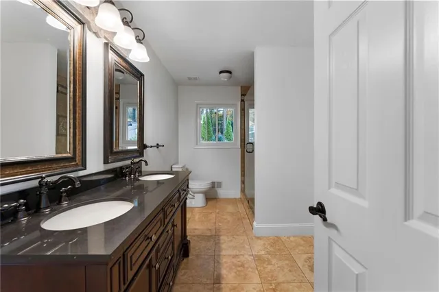 a bathroom with 2 sink and a mirror