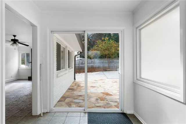 a view of a hallway with wooden floor and a living room