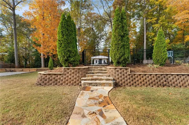a view of fountain with wooden fence
