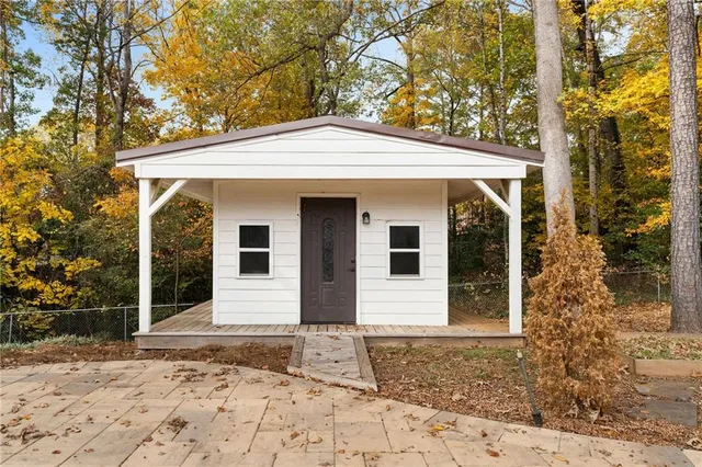 a view of a white house with large windows