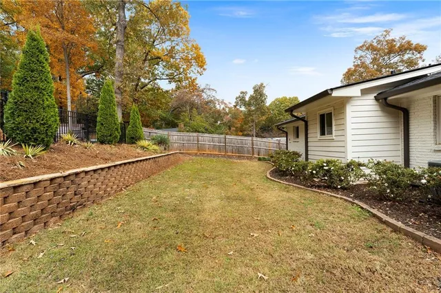 a view of a house with a backyard