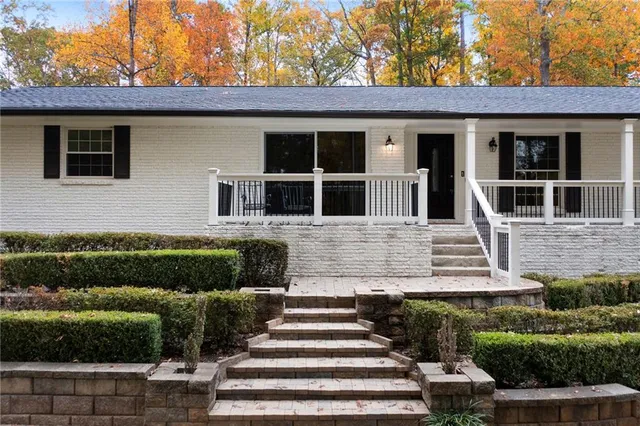 a front view of a house with a garden