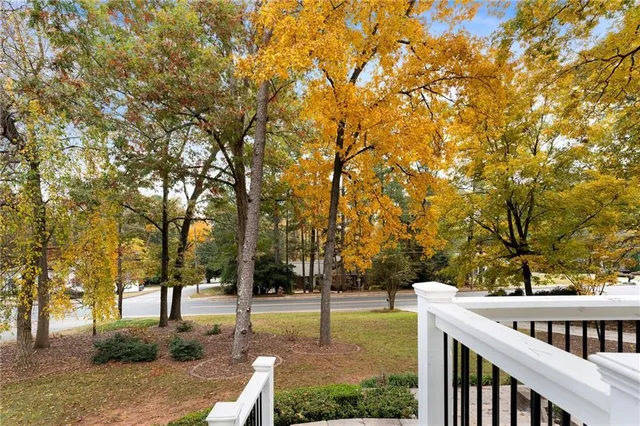 a view of a house with backyard and trees