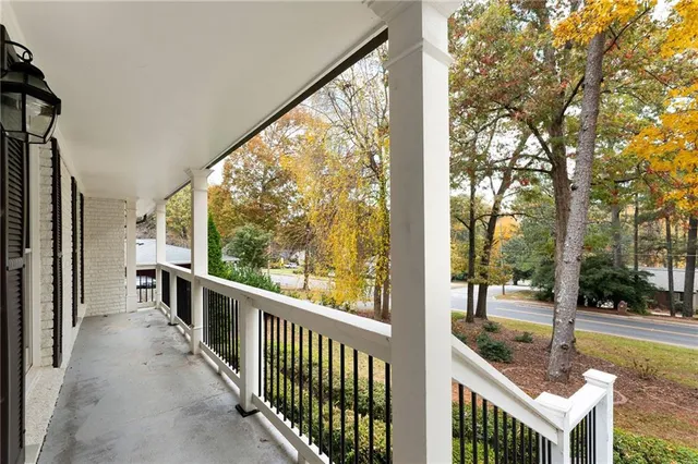 a view of a porch with wooden floor and fence