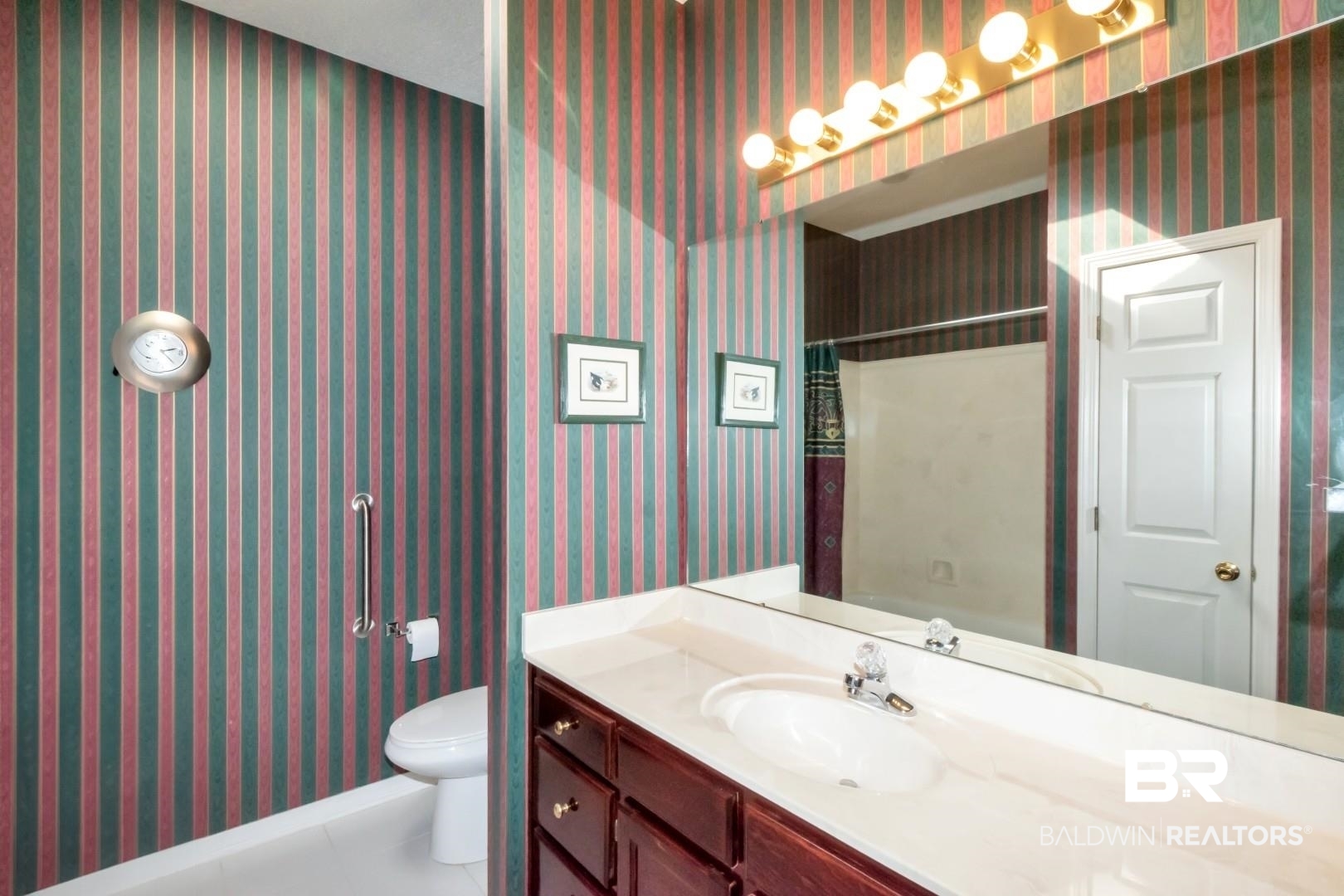 1032 Cross Gates Place Mobile, AL 36609 - Photo 22 of 34 Bathroom with wallpapered walls, vanity, curtained shower, and light tile patterned floors