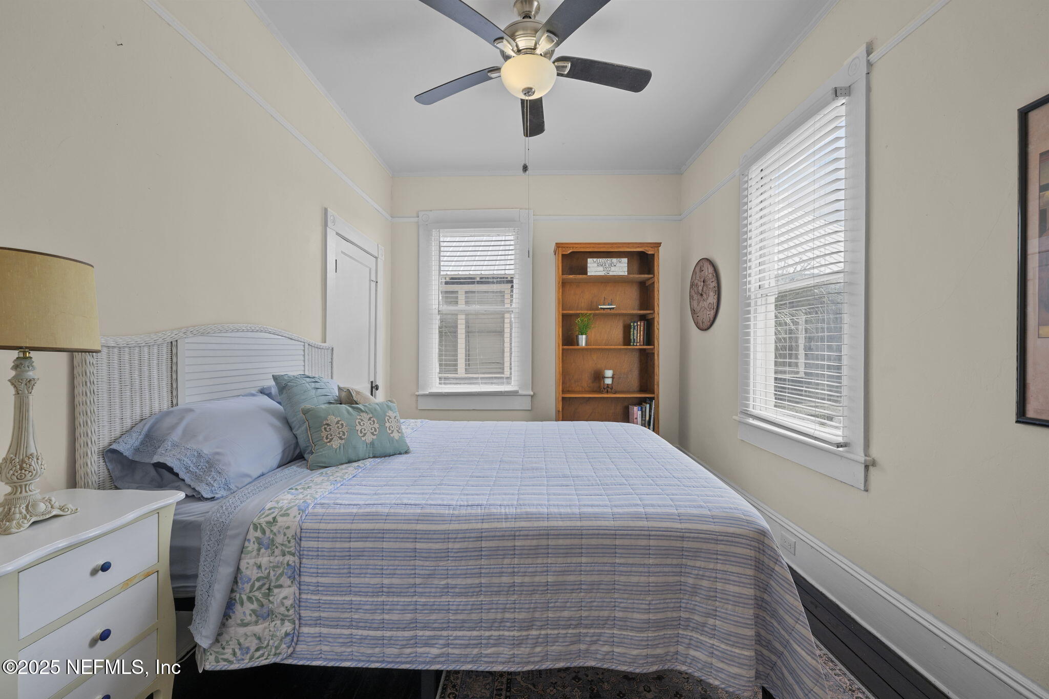 313 Madison Street Palatka, FL 32177 - Photo 14 of 38 a bedroom with a large bed and a chandelier