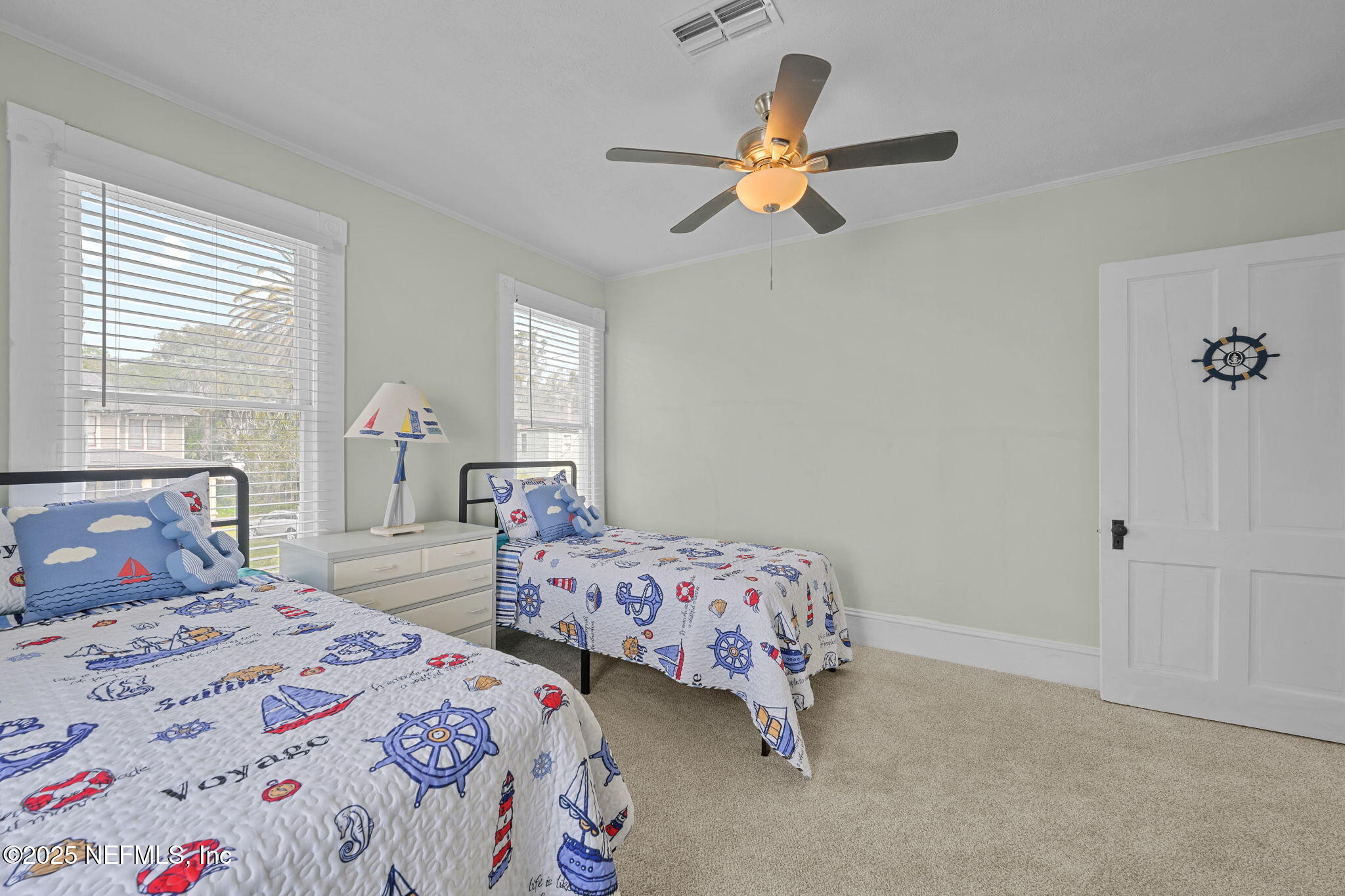 313 Madison Street Palatka, FL 32177 - Photo 24 of 38 a bedroom with two beds and a chandelier