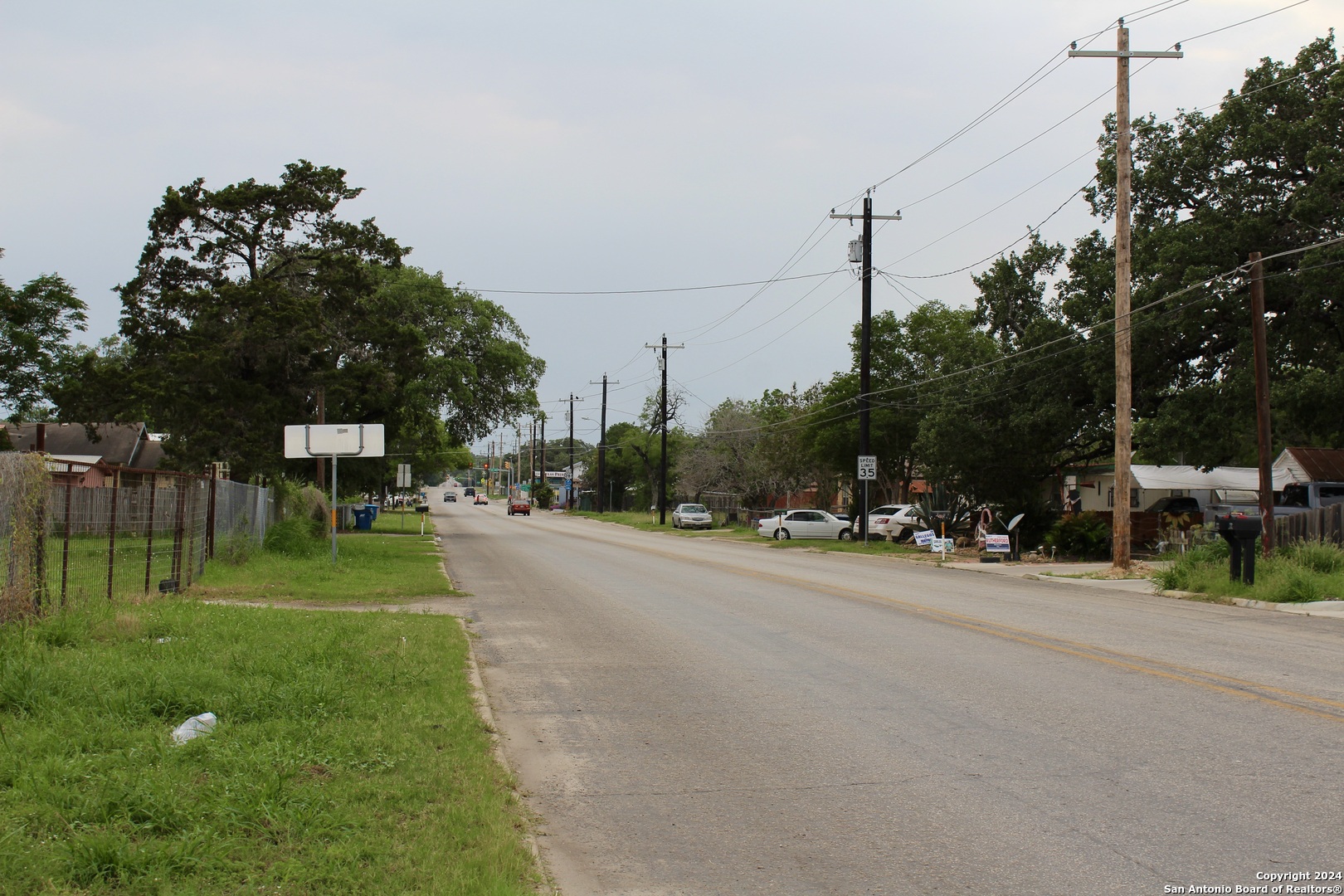 707 Commerce Street Pleasanton, TX 78064 - Photo 11 of 13 a view of a street with a building and a street sign