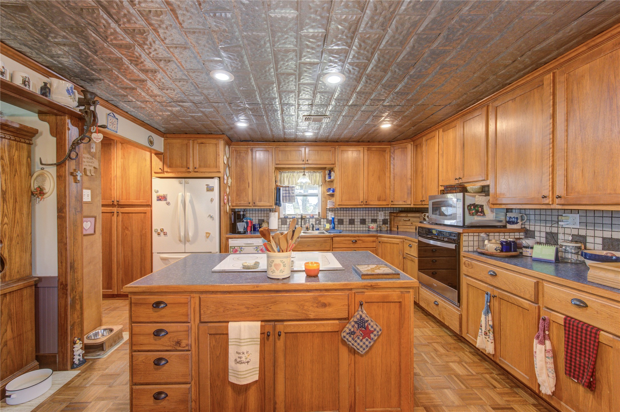 36239 Cochran Road Waller, TX 77484 - Photo 5 of 9 a kitchen with stainless steel appliances a refrigerator a sink dishwasher a stove and white cabinets with wooden floor