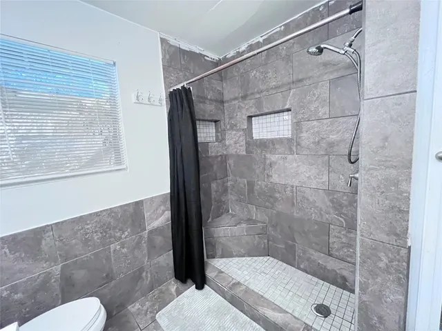 a bathroom with a shower and a toilet