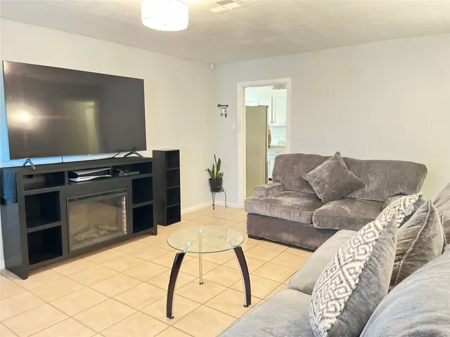 a living room with a couch and a flat screen tv