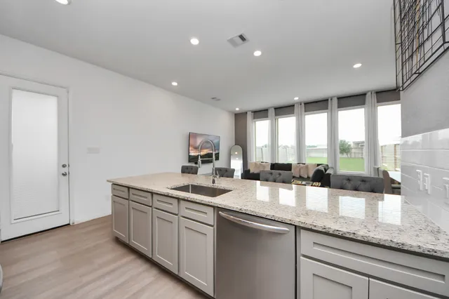 a kitchen with lot of counter space and a sink