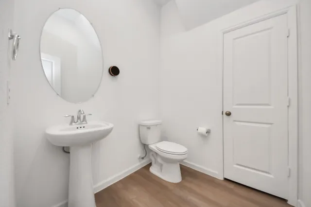 a bathroom with a sink toilet and a mirror