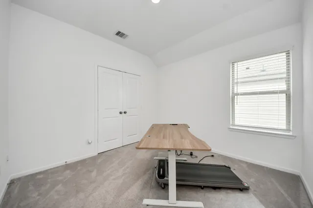 a living room with a table chairs and a window