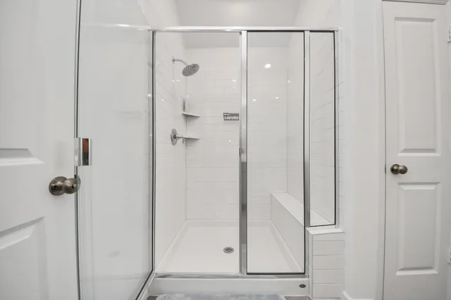 a bathroom with a glass shower door