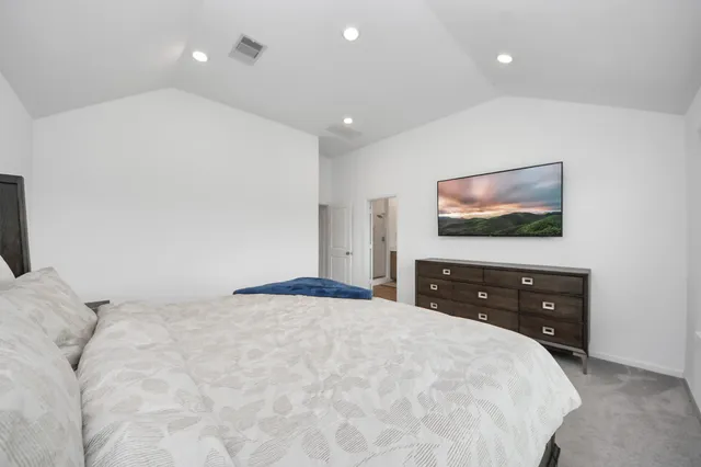 a bedroom with a bed and a flat screen tv