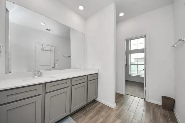 a bathroom with a double vanity sink and mirror