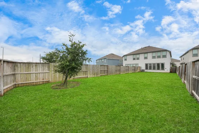 a front view of a house with a garden and yard