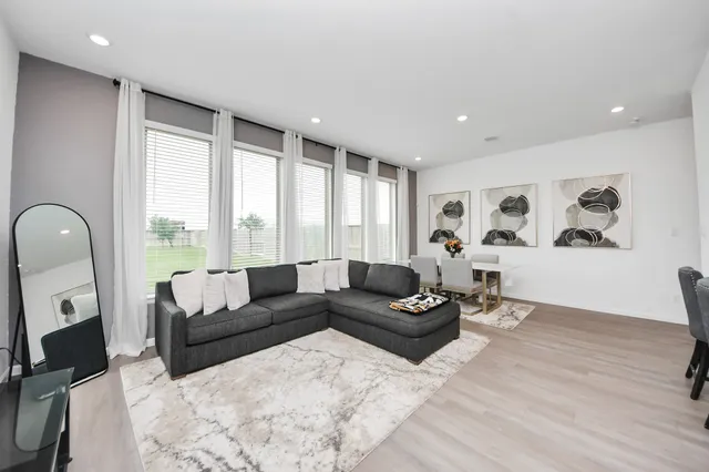 a living room with furniture and a large window