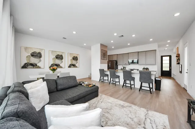 a living room with furniture and wooden floor