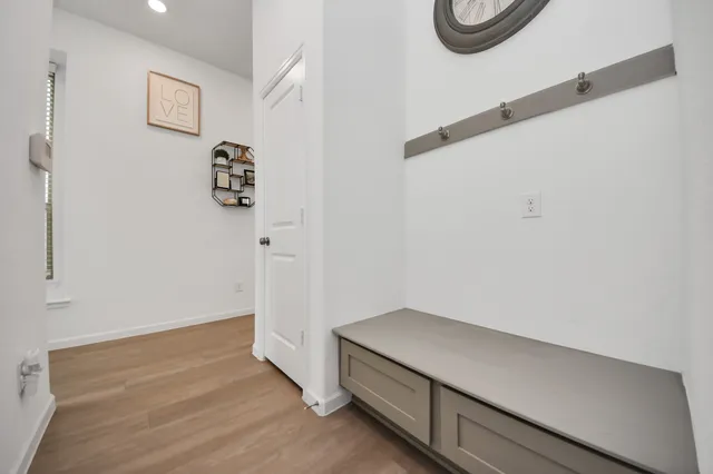 a room with a wooden floor and a white wall