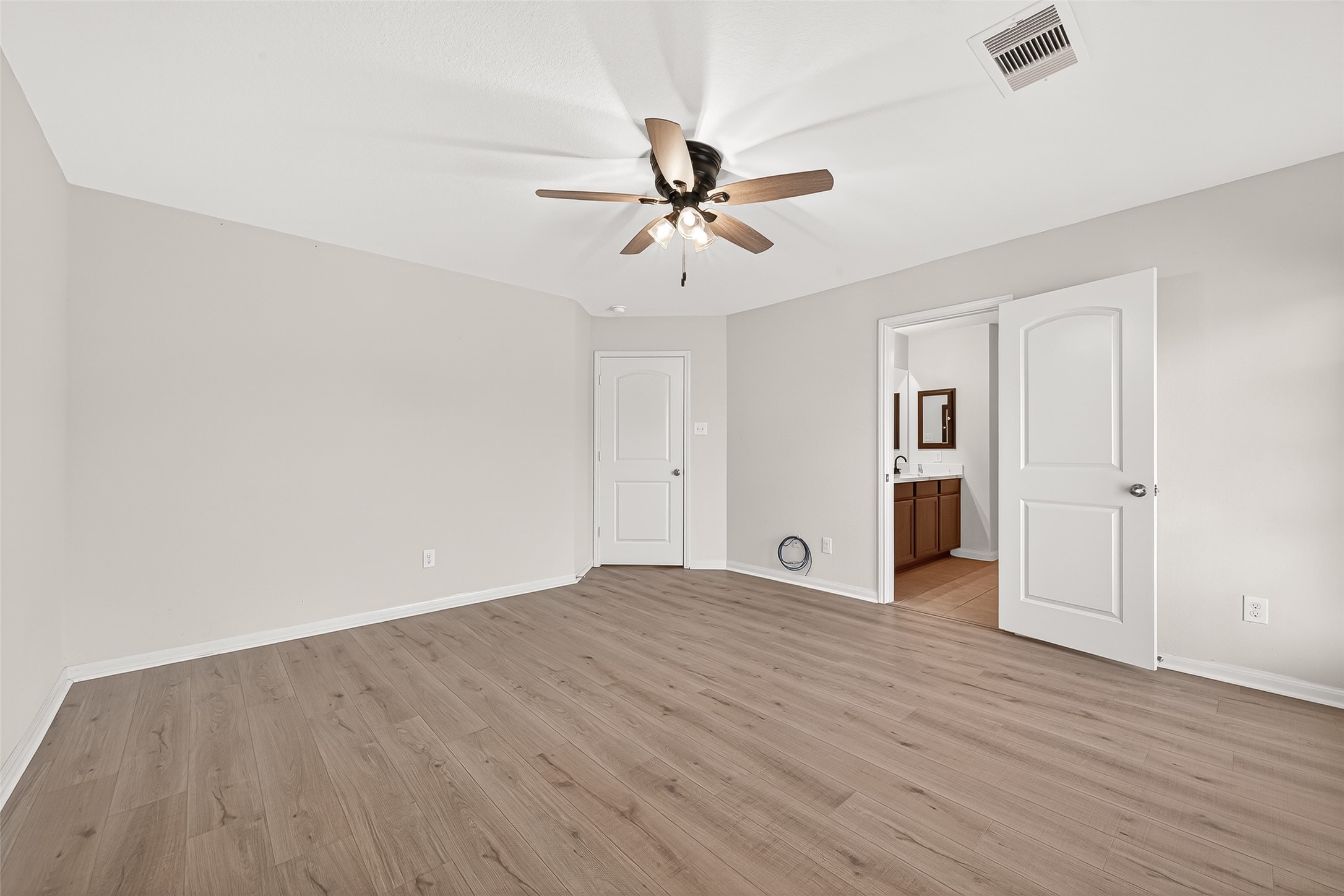 4918 Jagged Cliff Lane Rosenberg, TX 77469 - Photo 11 of 23 an empty room with wooden floor ceiling fan and windows