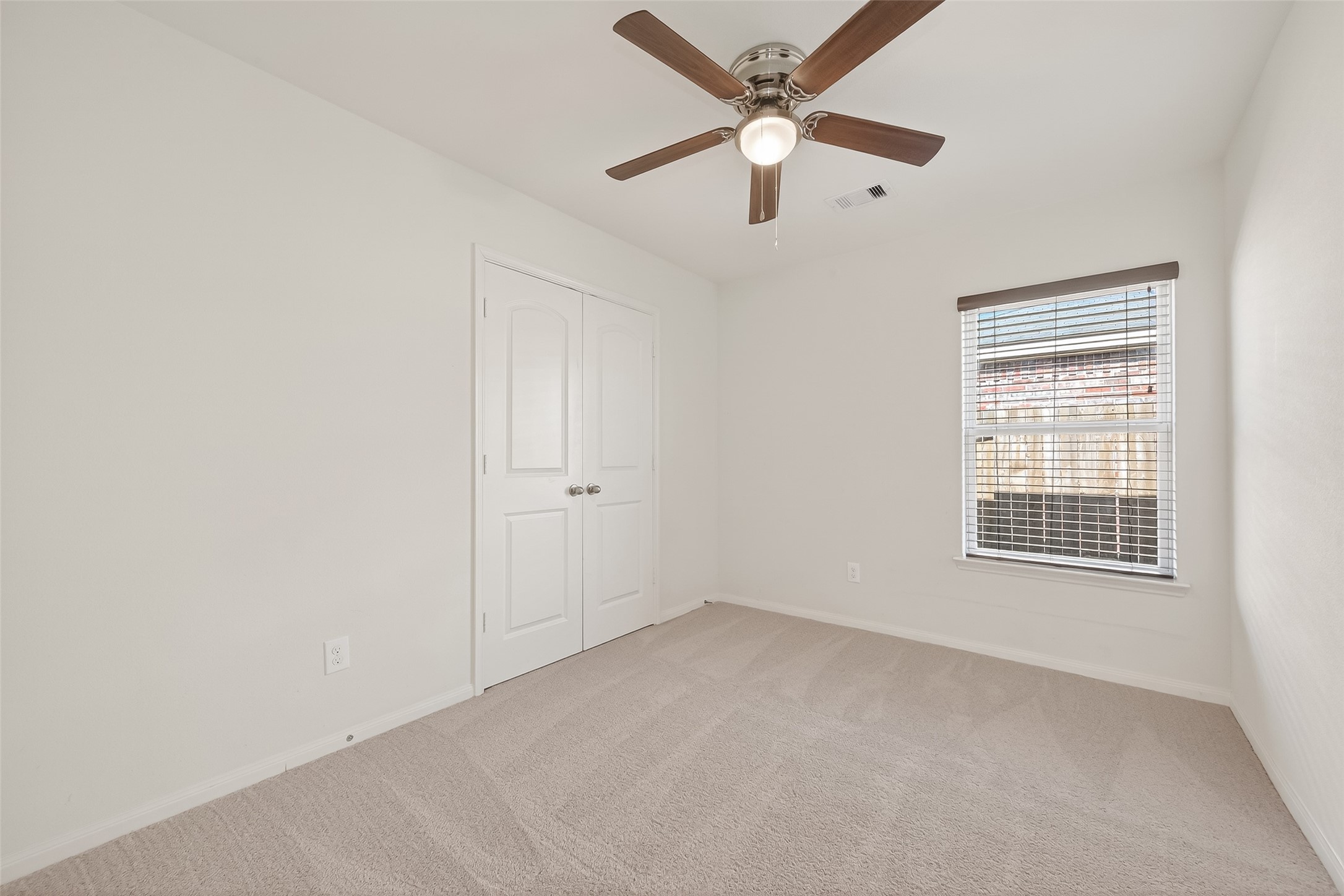 4918 Jagged Cliff Lane Rosenberg, TX 77469 - Photo 18 of 23 an empty room with a window and a fan
