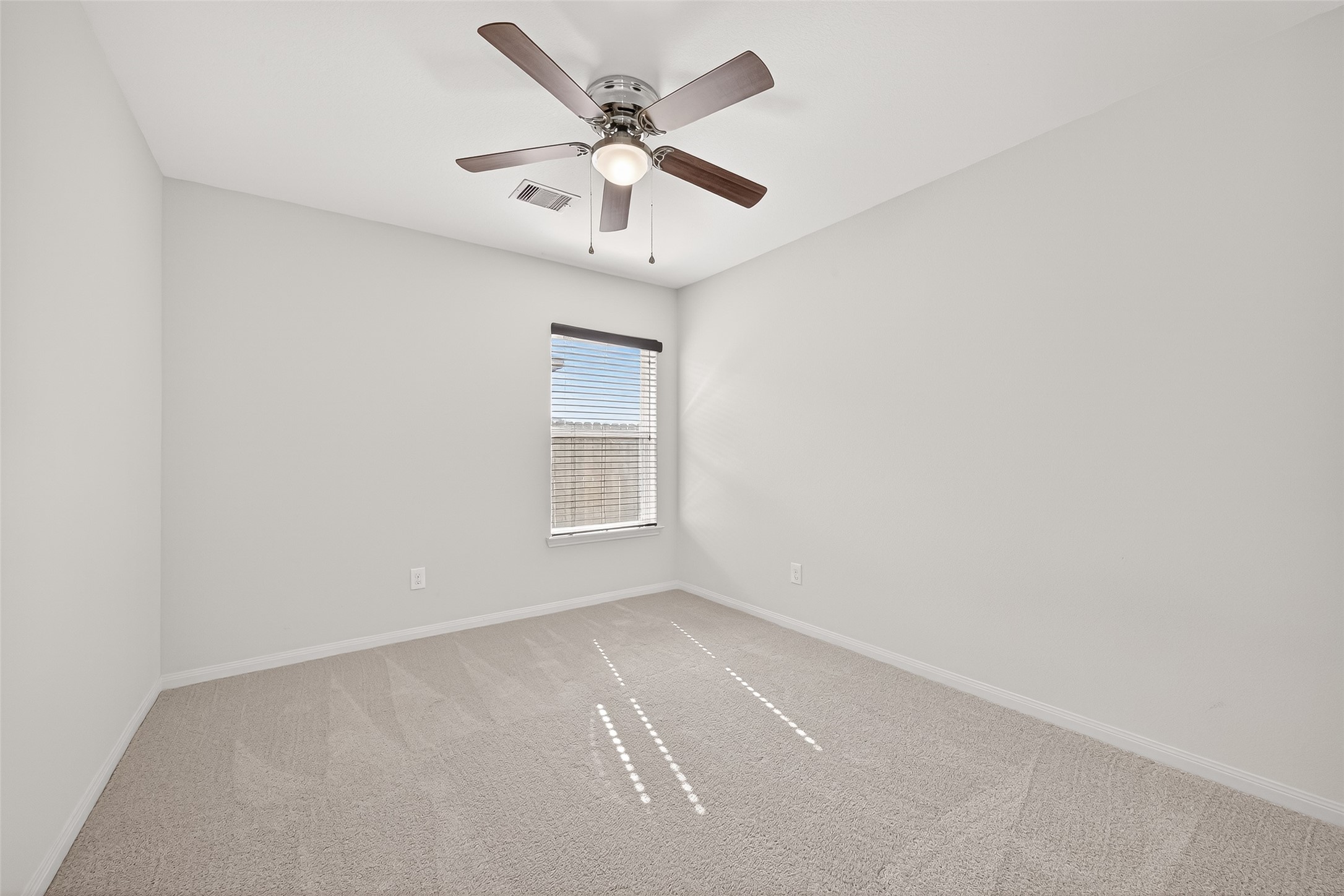 4918 Jagged Cliff Lane Rosenberg, TX 77469 - Photo 19 of 23 an empty room with a window and a ceiling fan