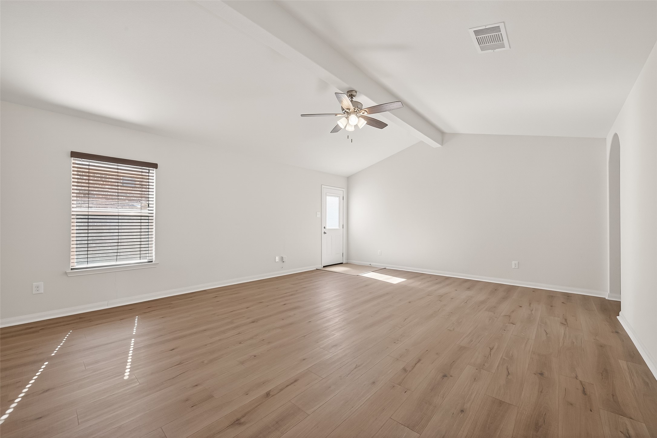 4918 Jagged Cliff Lane Rosenberg, TX 77469 - Photo 2 of 23 a view of an empty room with wooden floor and a window