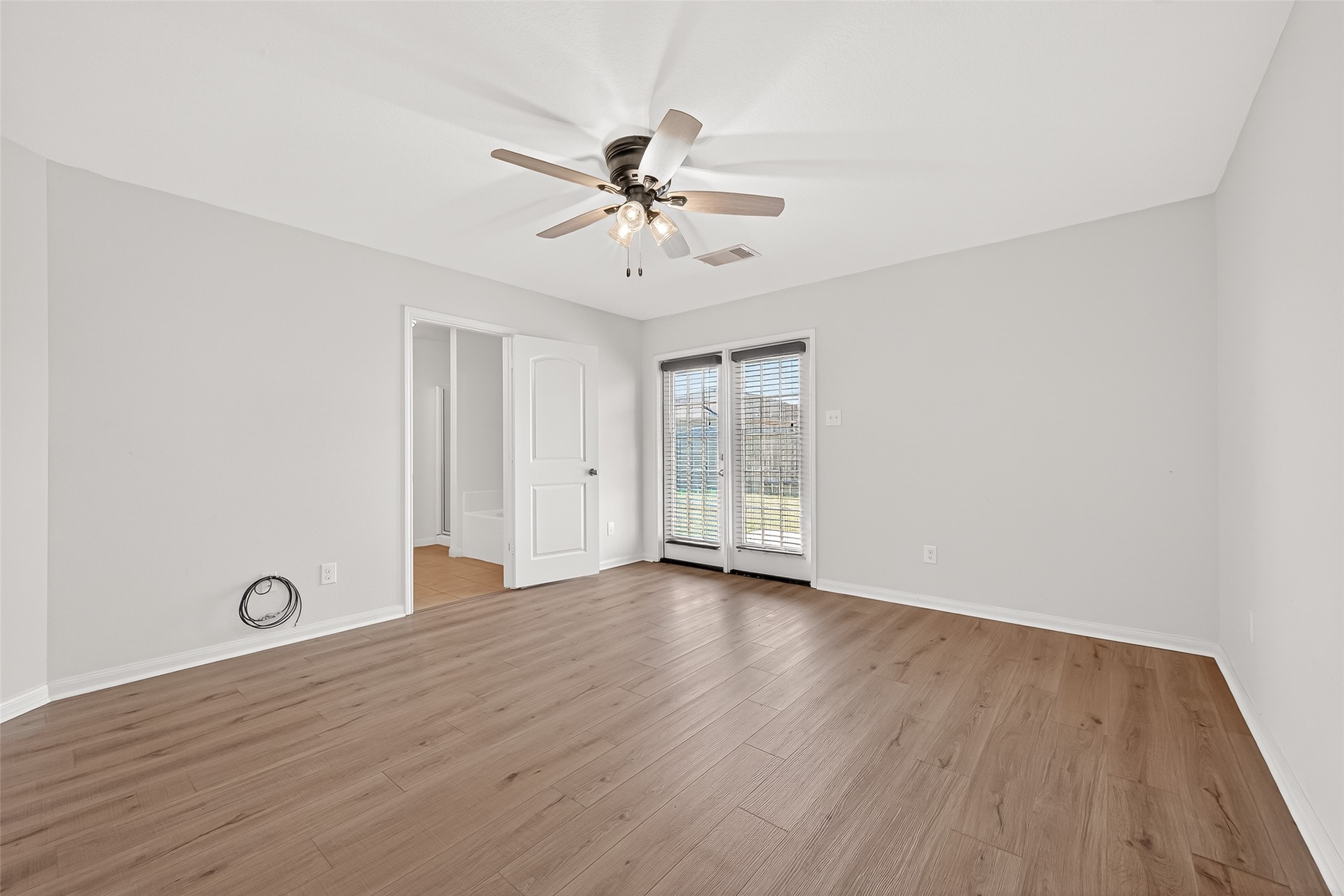 4918 Jagged Cliff Lane Rosenberg, TX 77469 - Photo 10 of 23 wooden floor in an empty room with a window