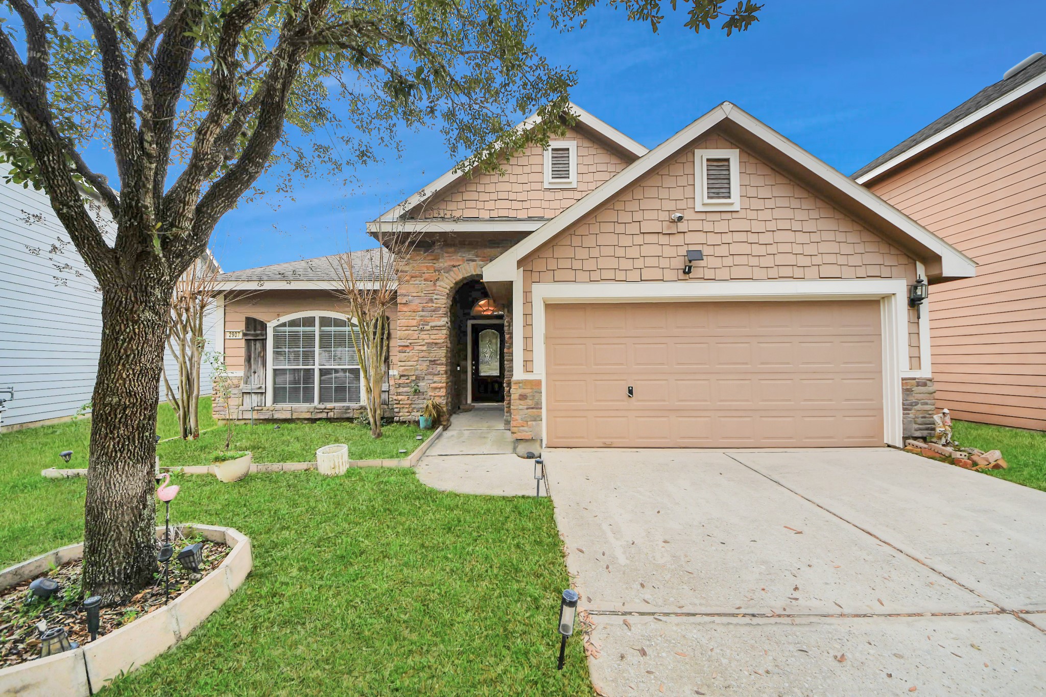a front view of a house with a yard and garage