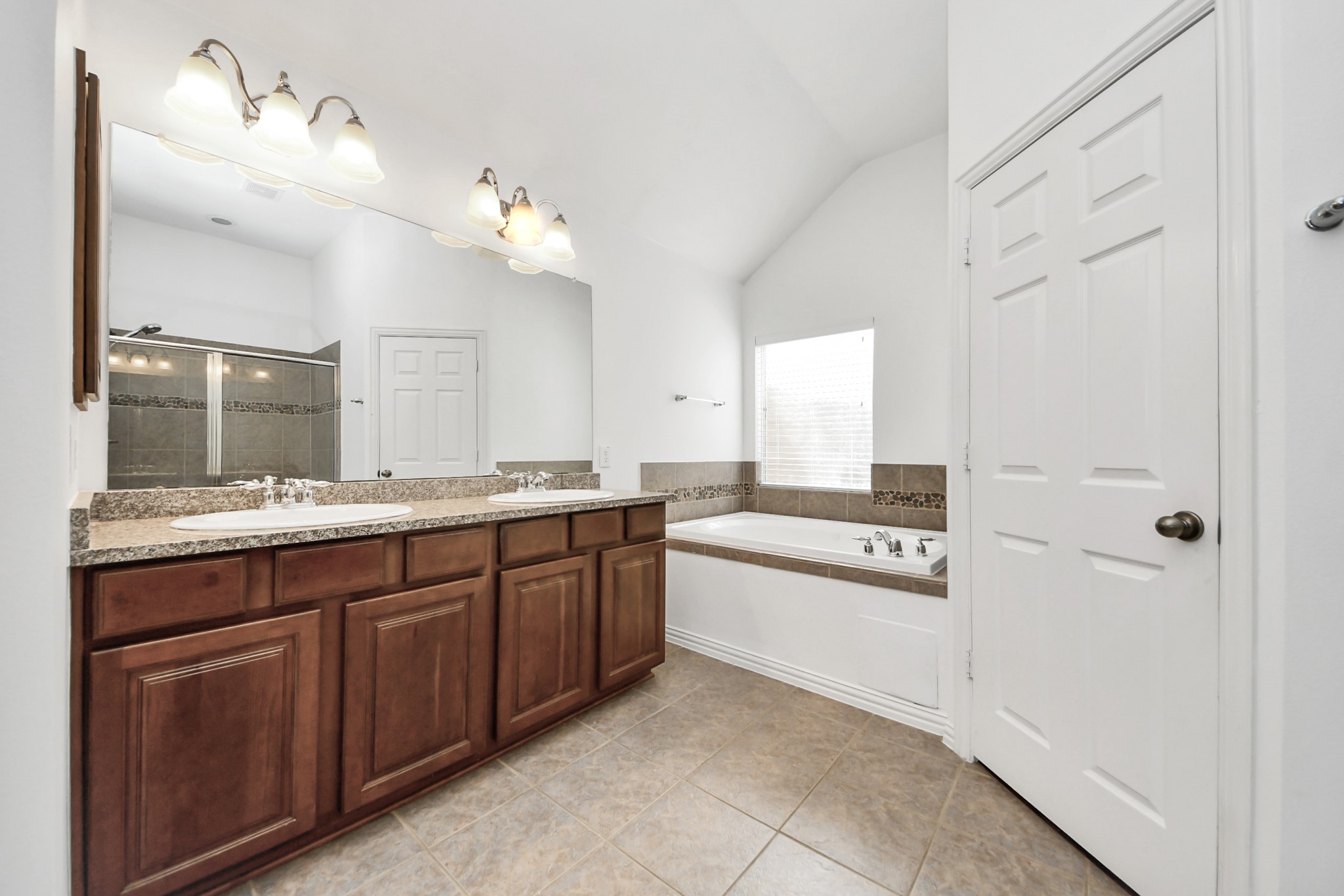 2907 Bright Sky Court Spring, TX 77386 - Photo 15 of 27 a large bathroom with a granite countertop sink a mirror and a bathtub