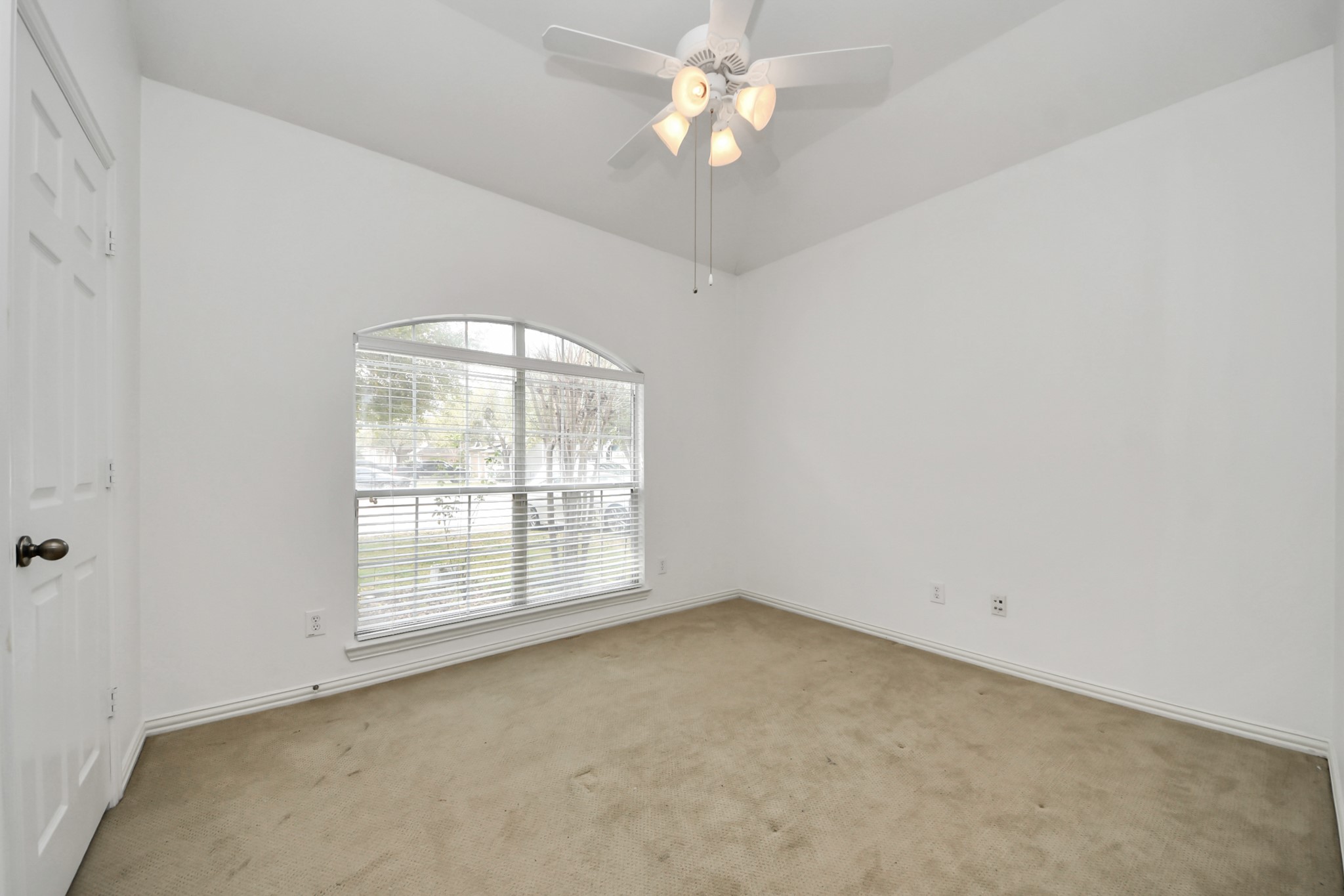 2907 Bright Sky Court Spring, TX 77386 - Photo 21 of 27 an empty room with a chandelier fan and windows