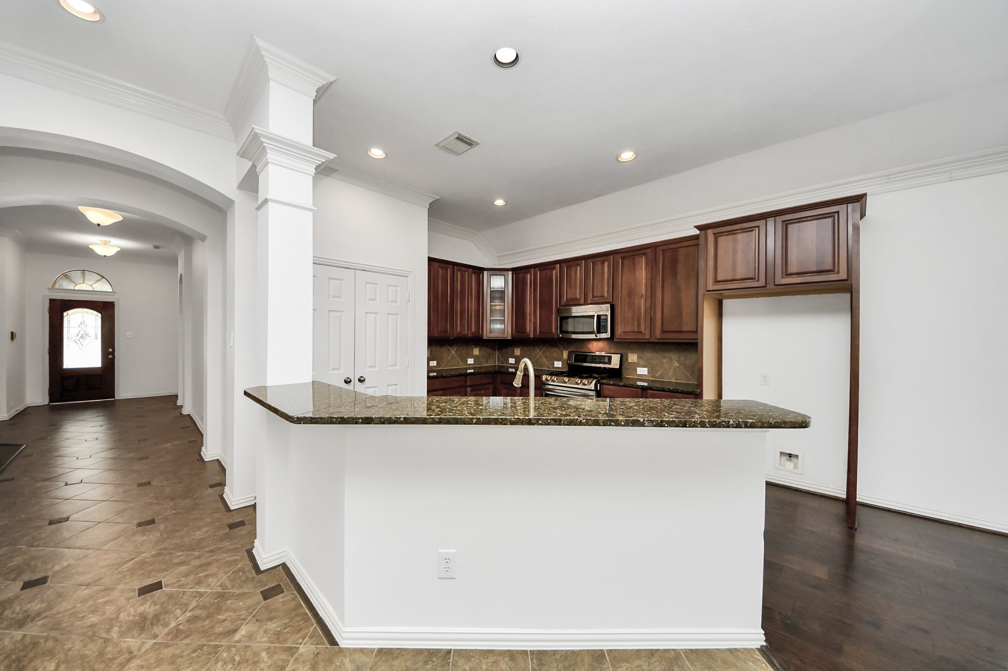 2907 Bright Sky Court Spring, TX 77386 - Photo 4 of 27 a view of a kitchen with kitchen island a counter top space a sink and appliances