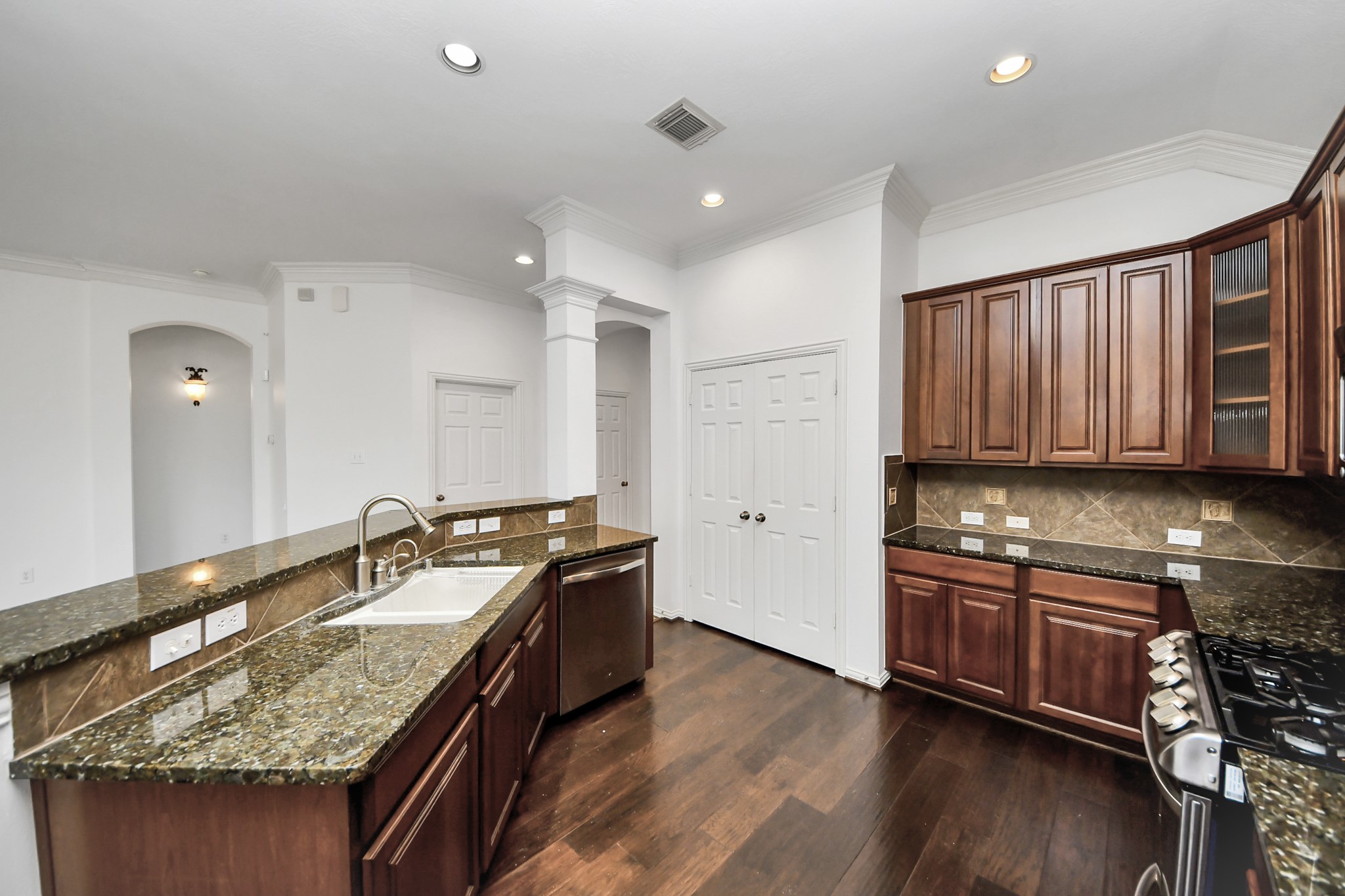 2907 Bright Sky Court Spring, TX 77386 - Photo 8 of 27 a kitchen with stainless steel appliances granite countertop a sink stove and cabinets