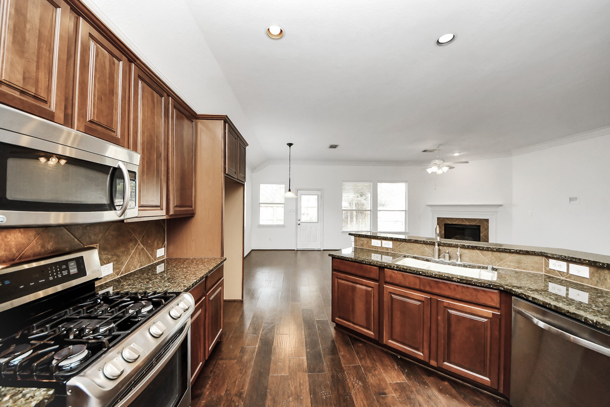 2907 Bright Sky Court Spring, TX 77386 - Photo 10 of 27 a kitchen with stainless steel appliances a stove a sink and a microwave