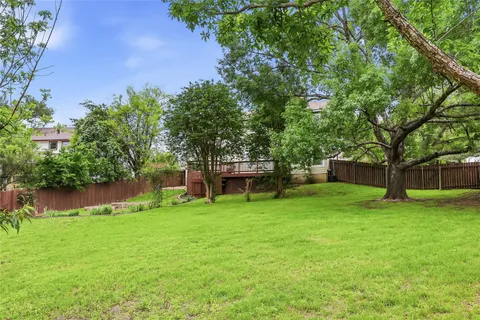 a view of a garden with a house in the background