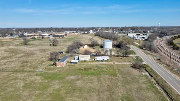 an aerial view of a houses with city view